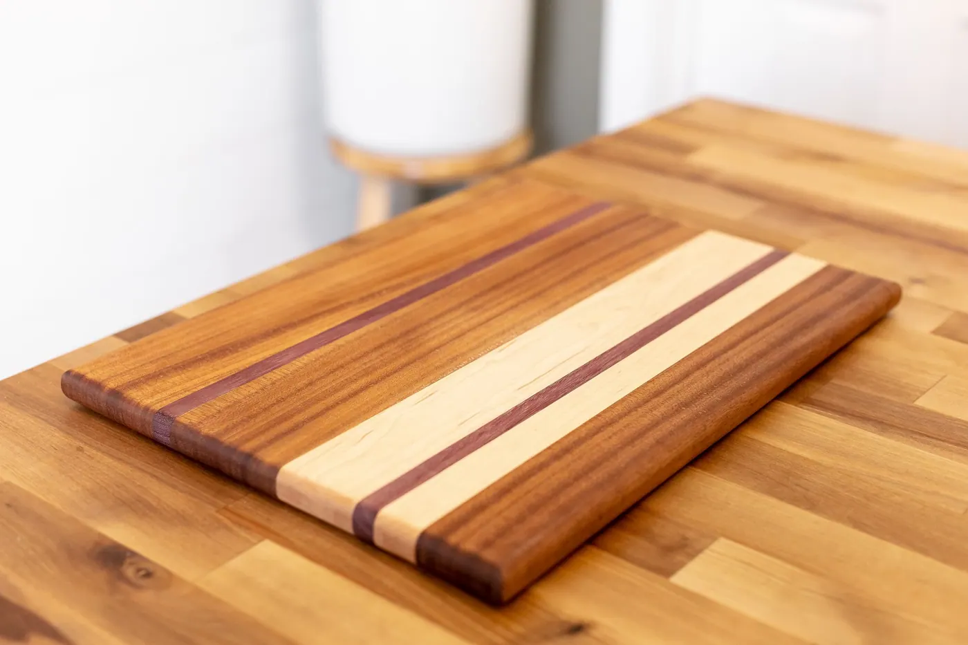 A striped hardwood cutting board on a table